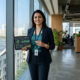 Professional Indian sustainability consultant holding a digital tablet, representing strategic carbon management and emission reduction.